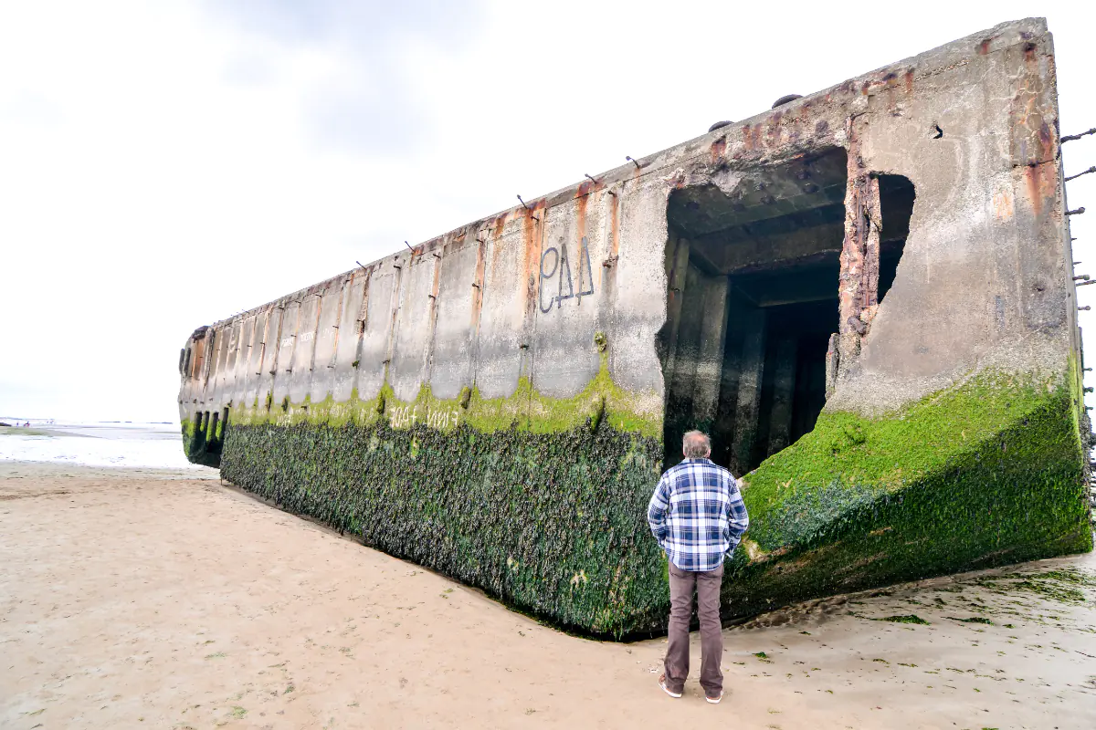 A view from the beach of left over pieces of the artificial harbor at Arromanches in Normandy, France.
