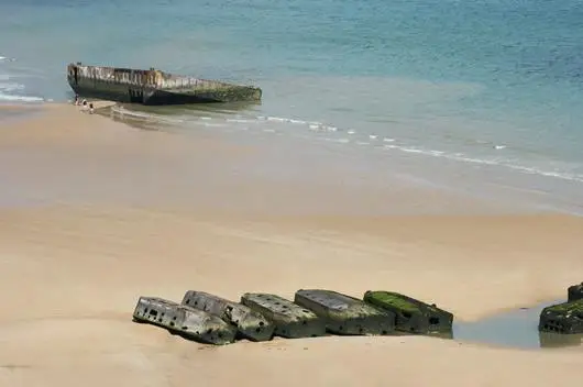 A view from the beach of left over pieces of the artificial harbor at Arromanches in Normandy, France.