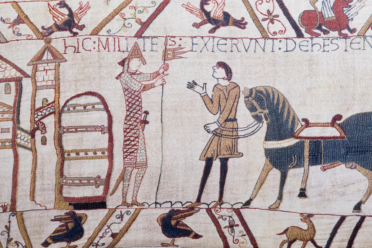 An image of two figures talking to one another as displayed in the Bayeux Tapestry.