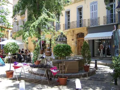 Empty chairs in a town square in Aix-en-Provence in summer.