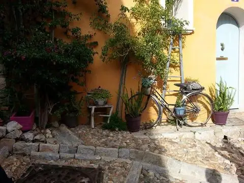 An old bike on a yellow house in Provence, France.