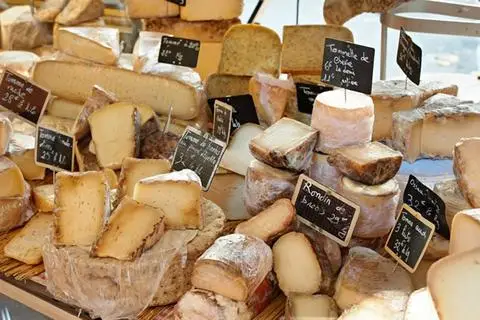A display case of French cheeses.
