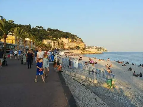Kids walk along the promenade near the beach in Nice, France.