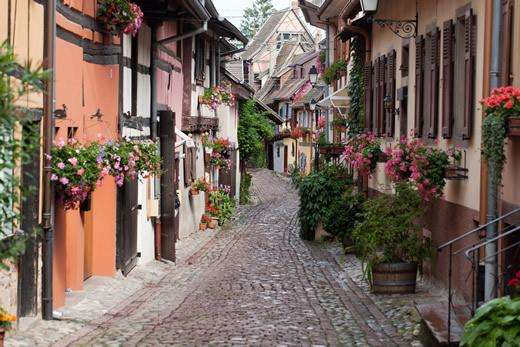 A cobblestone street in the village of Eguisheim, France.