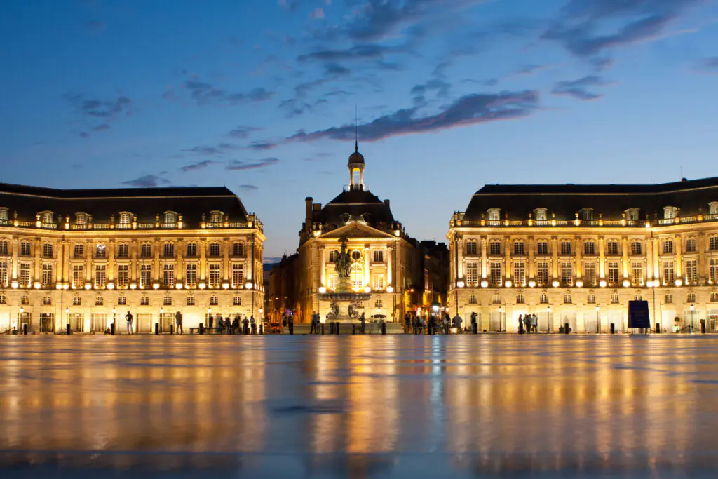 The illuminated Place de la Bourse in Bordeaux in the early evening.