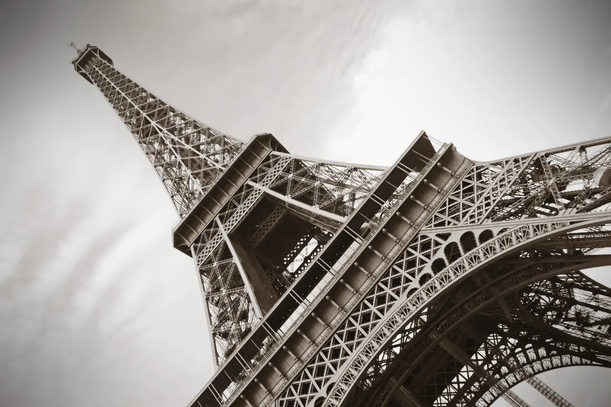 An angled black and white image of the Eiffel Tower in Paris.