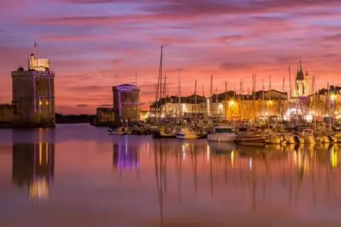 An image of La Rochelle from the harbor at sunset.