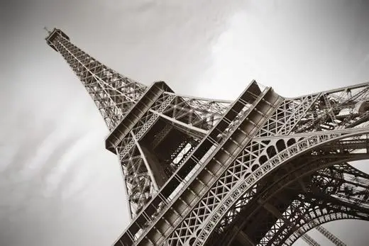 An angled black and white image of the Eiffel Tower in Paris.
