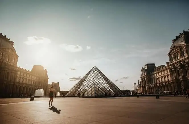 An early morning jogger runs near the Louvre in Paris, France.
