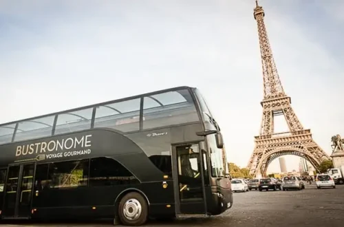 Bustronome luxury dining bus in front of the Eiffel Tower in Paris