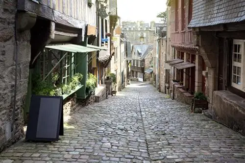 Mont Saint Michel Day Tour: a cobblestone street in the medieval town of Dinan, France.