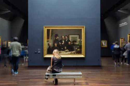 Visitors admiring Impressionist masterpieces at Musée d'Orsay in Paris