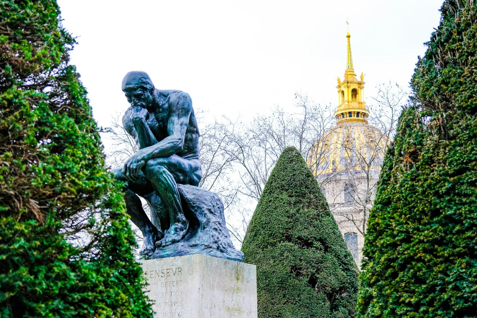 The Thinker in the Musée Rodin garden, with the gold dome of Les Invalides behind
