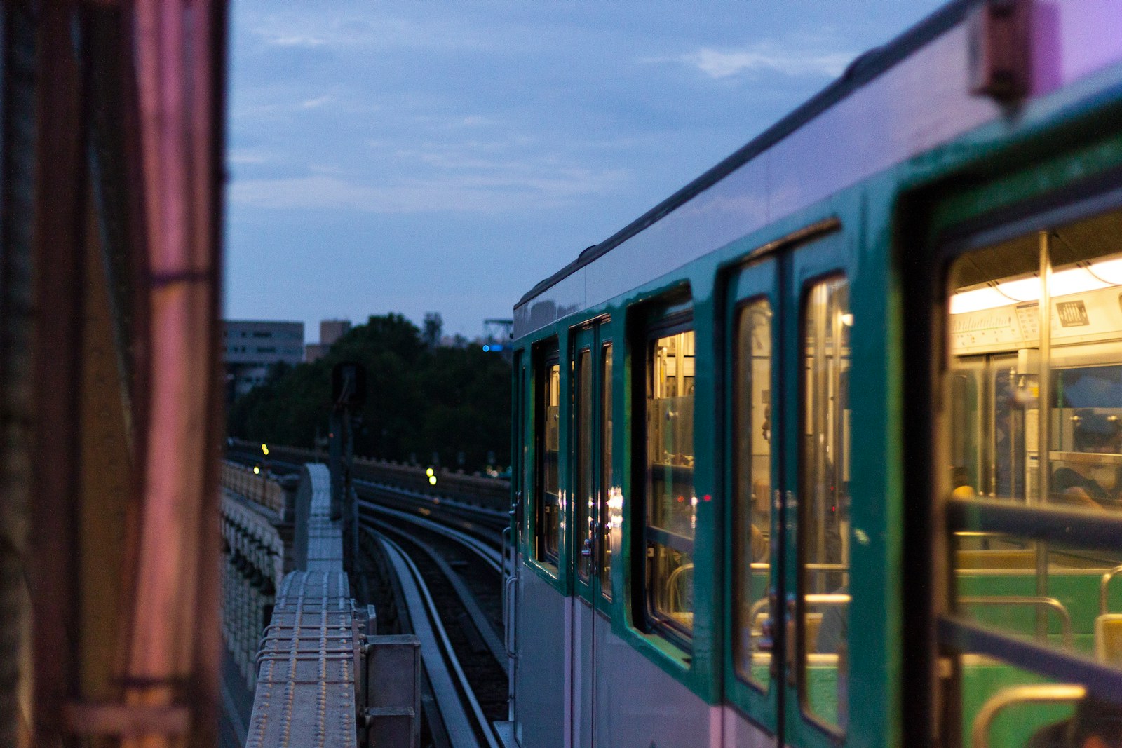 A line 6 metro train on the elevated track over the Seine