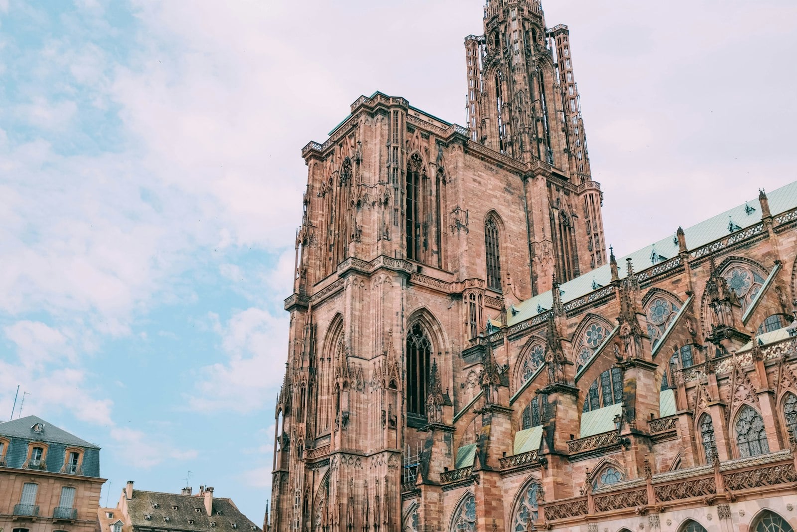 The spire and south flank of Strasbourg cathedral in pink sandstone.